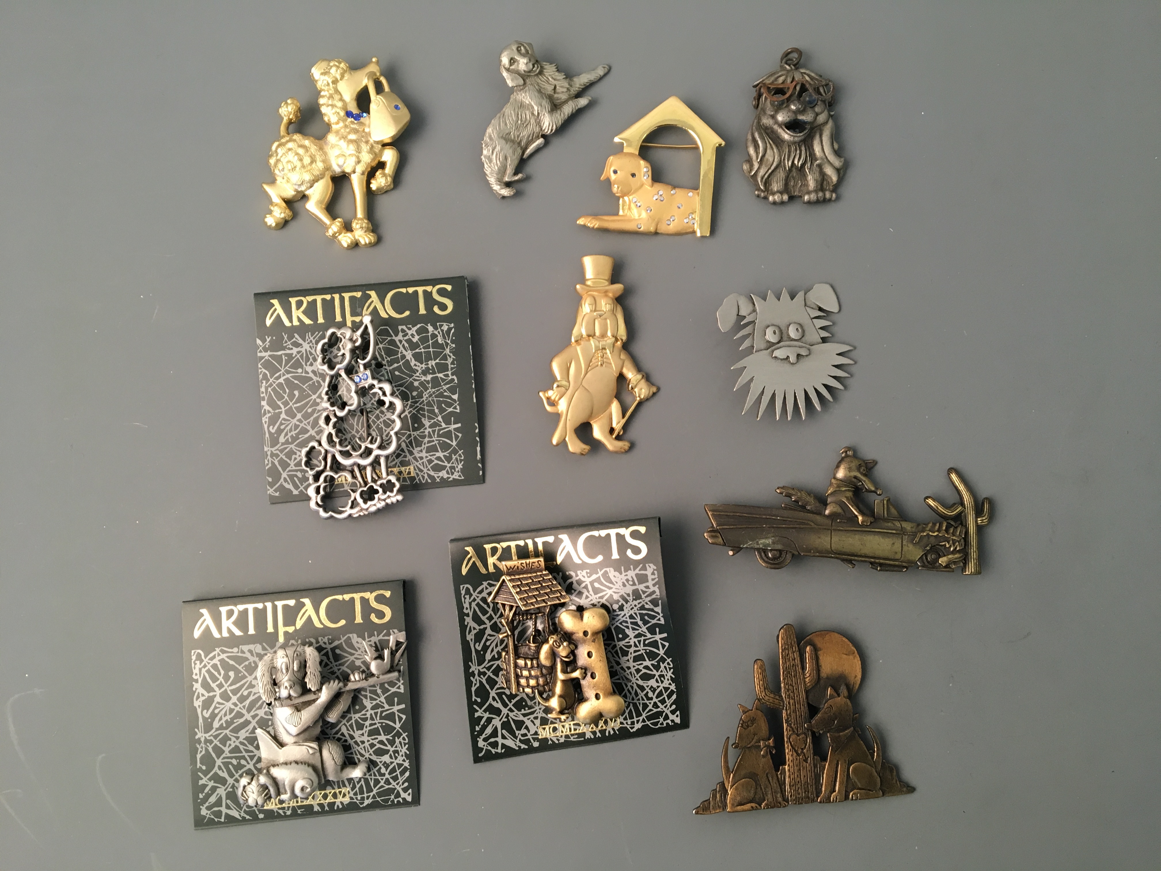 Eighteen Jonette Jewelry dog and reptile pin brooches, one badge and one pendant. Online viewing and