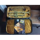 A trumpet in fitted box with teaching book. IMPORTANT: Online viewing and bidding only. No in person