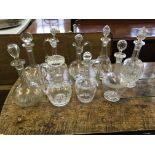 Nine various cut and moulded glass decanters with stoppers. IMPORTANT: Online viewing and bidding