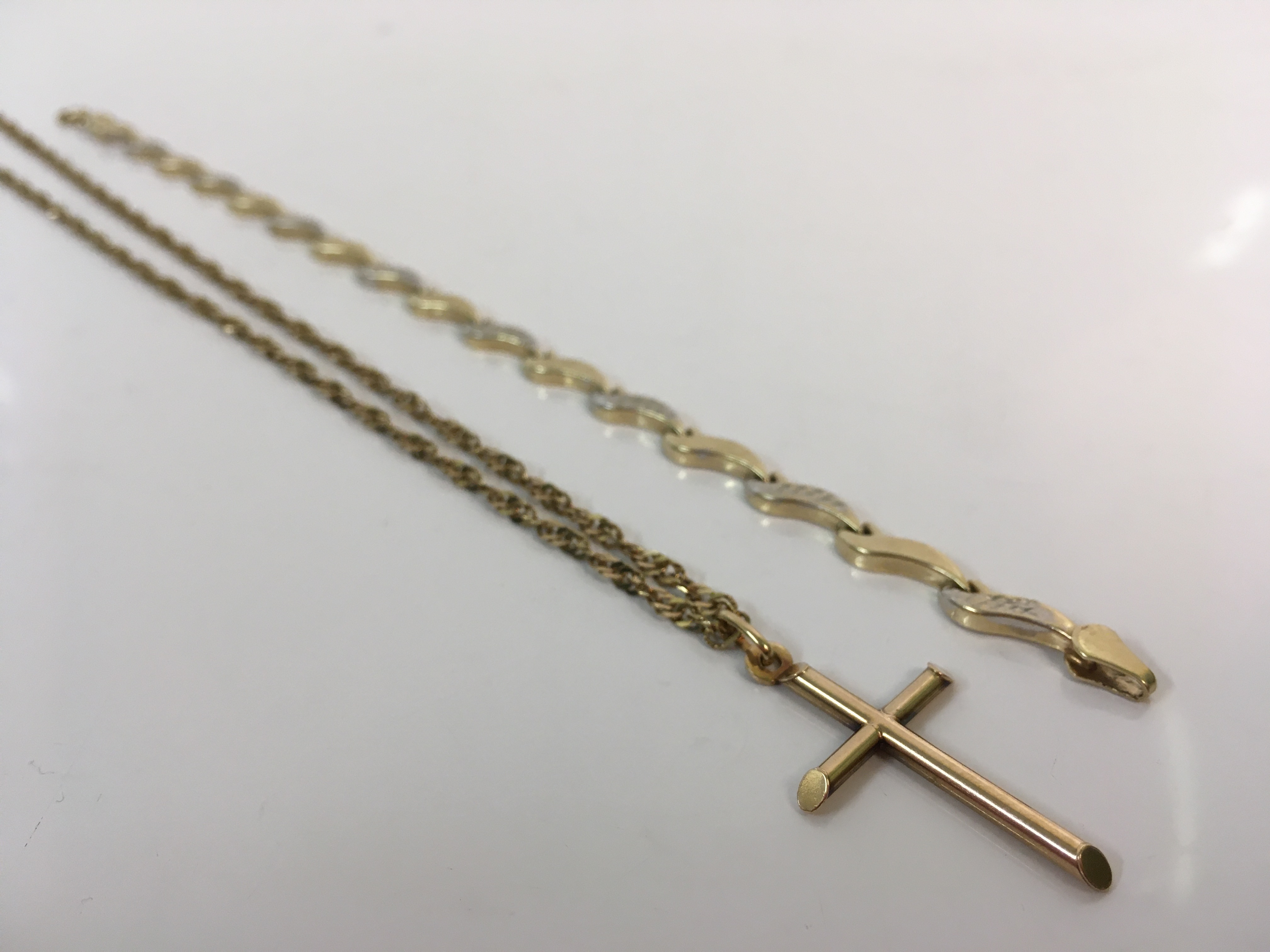 A 9ct yellow gold cross on chain, stamped 375, with a 9ct yellow gold bracelet, stamped 9k,