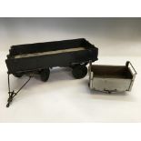 A model metal trailer wagon with a metal mining cart. IMPORTANT: Online viewing and bidding only. No