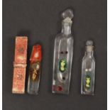 Three 19th Century clear glass scent bottles, two with verre eglomise style green glass and gilt