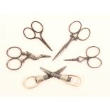 Five pairs of 19th Century scissors, comprising a folding chatelaine pair with white metal arms