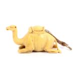 A celluloid novelty tape measure in the form of a seated camel, complete retractable printed tape,