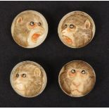 A set of four late 19th Century Japanese domed ivory buttons, each carved with a monkey's head
