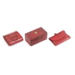 Three Regency red leather sewing accessories, comprising a small rectangular box with swivel