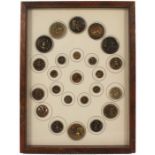 Buttons - a framed display of twenty four, mostly brass relief, some blackened, all featuring
