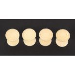 A set of four 19th Century ivory reel holders, the decorated tops with ball form borders, 3cm