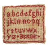A miniature sampler, worked in red with a lower case alphabet and inscribed 'Bessie', 3.2 x 3.5cm.Ê