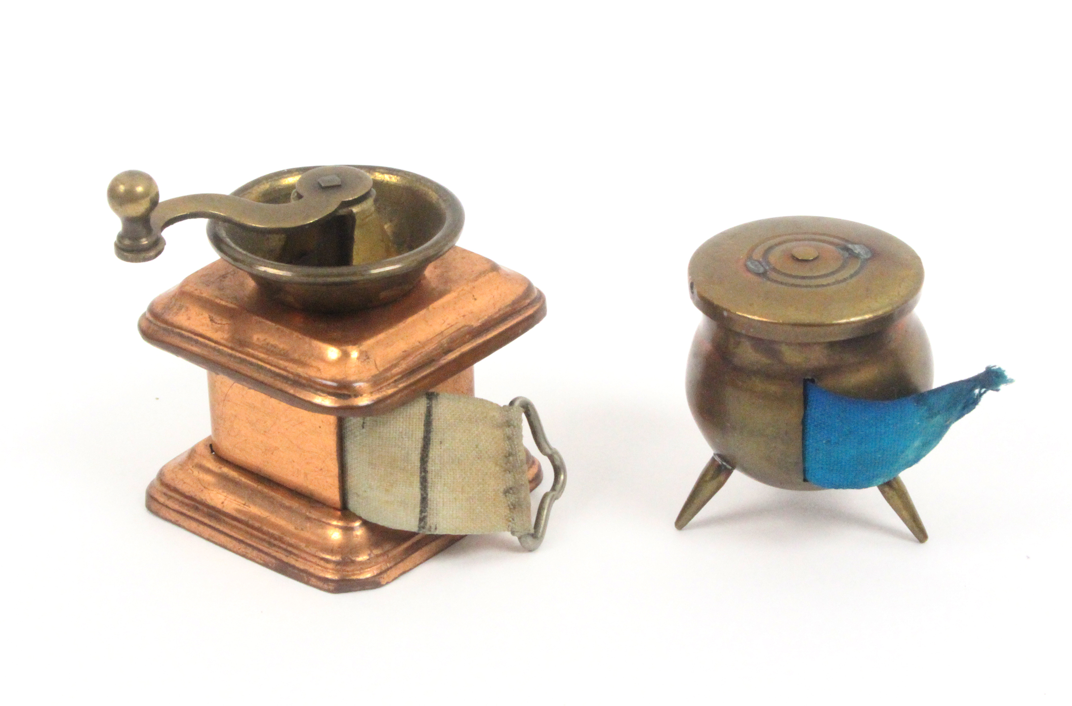 Two novelty tape measures, comprising a brass cauldron, complete tape in inches and cm. marked '