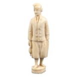 An early 19th Century Dieppe carved ivory needle case in the form of a fisherman in traditional