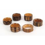 Six variant Tunbridge ware napkin rings, in stickware and mosaic one with bone inset numeral, one