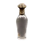 An attractive scent bottle, the baluster shaped glass body below a fancy silver gilt hinged cover