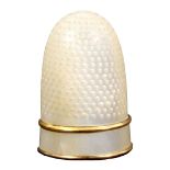 A mother of pearl Palais Royal style thimble, the plain frieze between copper gilt bands. From a