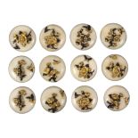 A fine set of twelve late 19th Century Japanese domed ivory buttons decorated with Shakudo