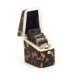 A tortoiseshell needle packet box of knife box form, the lid with white metal plaque, the interior