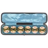 Buttons - a cased set of six large late 19th Century enamel decorated buttons each with a central