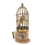 An Austrian cold painted brass novelty tape measure in the form of a bird cage, the tape wound by