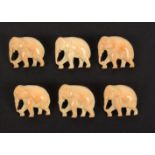 A set of six early 20th Century ivory buttons, each realistically carved and pierced as a standing
