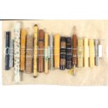 A collection of eighteen cylinder form knitting needle containers, in metal, wood, and plastics,