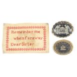 A miniature sampler and two mourning brooches, the sampler worked in red and inscribed 'Remember