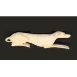 A fine 19th Century carved ivory needle case in the form of a recumbent dog, well detailed with paws