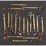Seventeen bone lace bobbins, including a beadwork decorated example, a gold foil spiral, five