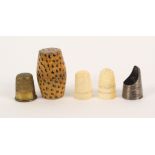 Four thimbles and a thimble case, comprising a ribbed silver finger guard, two 19th Century ivory