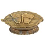 An Avery style pin box, in gilt brass the base of oval reeded form below a swivel lid with a