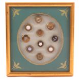 Buttons - a framed display of ten mid and late 19th Century brass mounted buttons mostly with