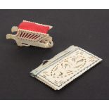 A cut and pierced bone pin cushion and a 19th Century ivory needle book, the first in the form of