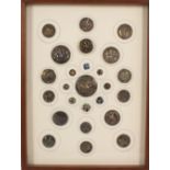 Buttons - a framed display of twenty five, comprising sixteen silver examples including six of