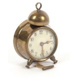 A brass novelty tape measure in the form of an alarm clock, the complete printed tape in ins. and