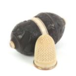 A fine early 19th Century thimble case with ivory thimble, the case in turned coquilla carved with