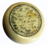 A late 18th Century ivory circular box, the lid inset with a painted panel of an eye under glass,