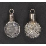 Two 19th Century miniature scent bottles, each of cut circular clear glass with silver screw tops