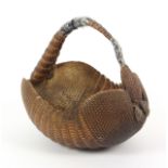 A 19th Century basket formed from an armadillo, handle with Sellotape repairs, 28cm.Ê