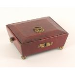 A Regency red leather covered sarcophagal form small sewing box, raised on gilt brass ball feet with