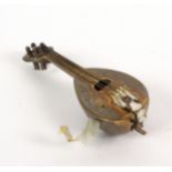 A lacquered brass novelty tape measure in the form of a mandolin, complete tape printed in ins.
