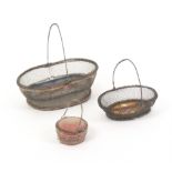 Two 19th Century wire mesh pin baskets and a similar pin cushion, the baskets of oval form, each