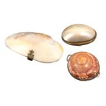 Two shell form purses and an egg, comprising a spiral example, brass hinged rim, 6.5cm, another of