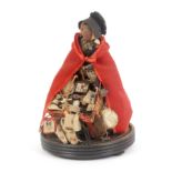 A good example of a Victorian pedlar doll, on ebonised base under a glass dome, the doll with