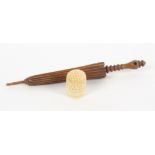 A needle case and a thimble, the wooden needle case in the form of a furled umbrella, 13cm, and a