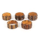 Five variant Tunbridge ware napkin rings, in stickware, 4.5cm dia. (5)