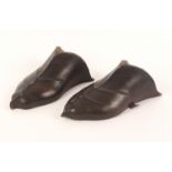 A pair of carved mahogany feet, in the medieval style perhaps to simulate an armour, 24cm. (2)