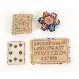 Four pin cushions and retainers, comprising a rectangular sampler form example, some loss, 7.5cm,