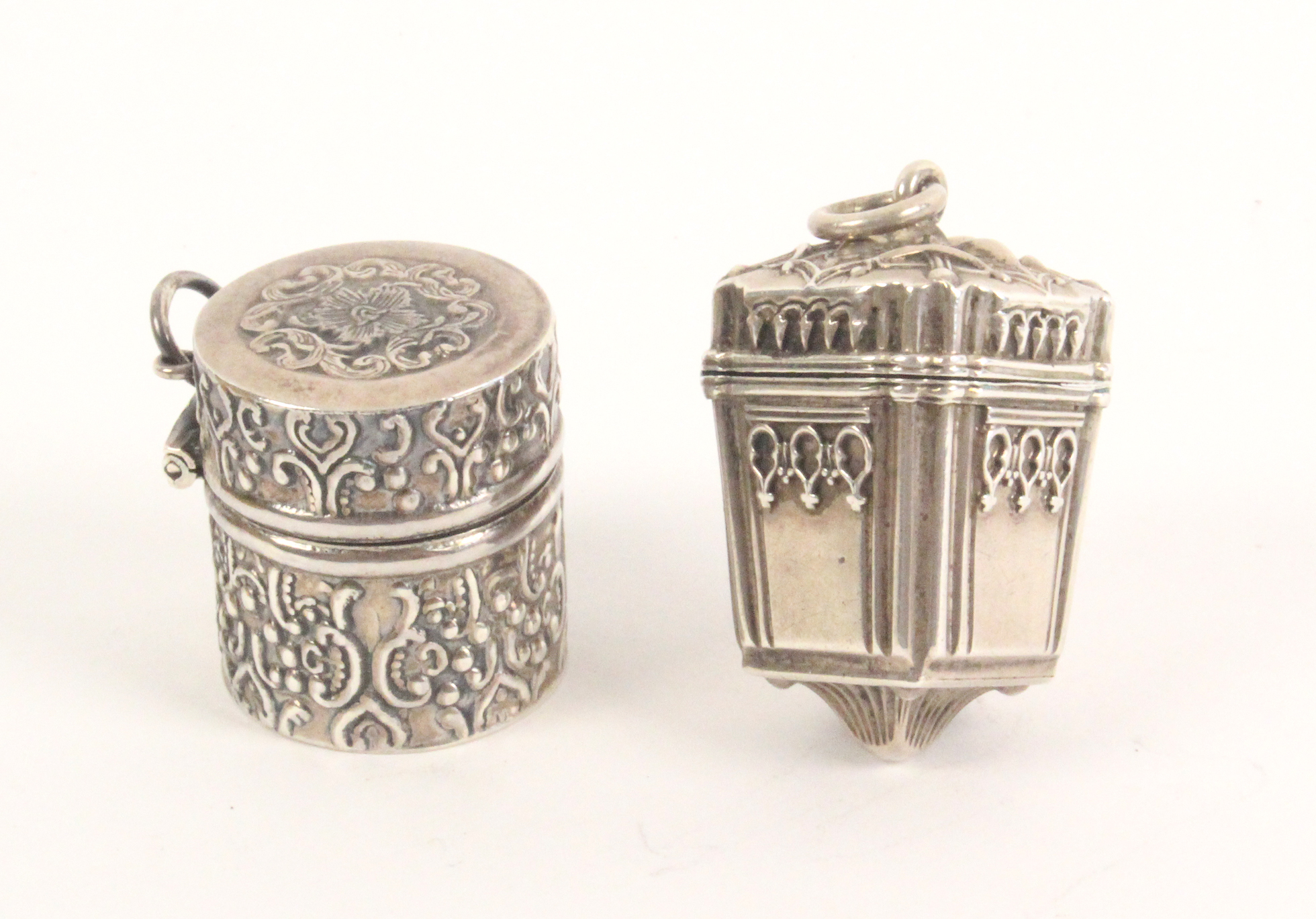 A silver vinaigrette and a thimble box, the first of square section and tapering form with decorated