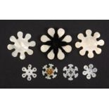 Seven mother of pearl thread winders, all of snowflake form comprising three Chinese floral and