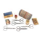 A mixed lot - sewing, comprising five pairs of steel scissors, largest 10cm, two needle packet