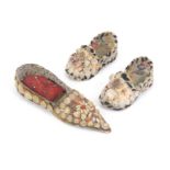 A pair of shell work miniature shoes and a slipper form pin cushion, some losses to the pair, 9cm